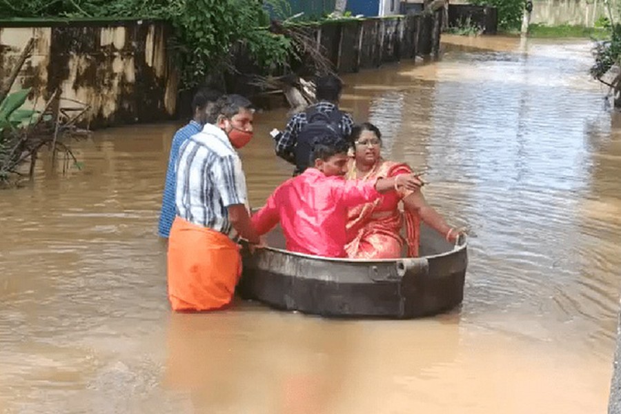 Bride and groom float to a temple in a cooking vessel on a flooded road for their wedding ceremony in this screengrab taken from video, in Alappuzha, Kerala, India, October 18, 2021. Picture taken October 18, 2021. REUTERS TV/via REUTERS