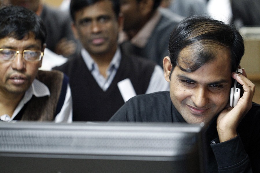 Investors react while monitoring stock price movements on computer screens at a brokerage house in the capital city — FE/Files