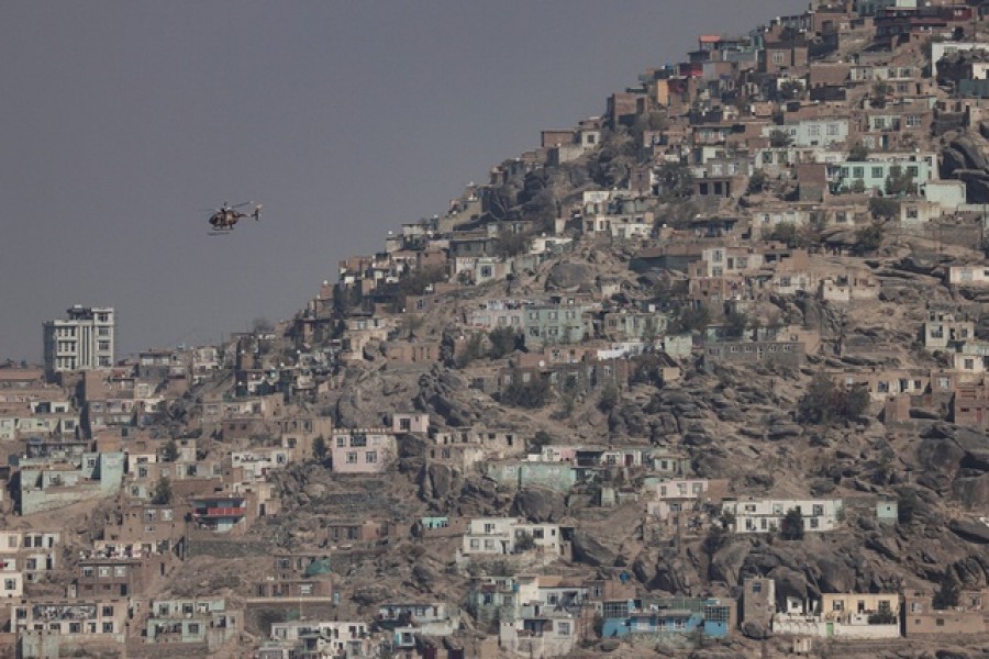 A military helicopter is pictured flying over Kabul, Afghanistan November 4, 2021.REUTERS