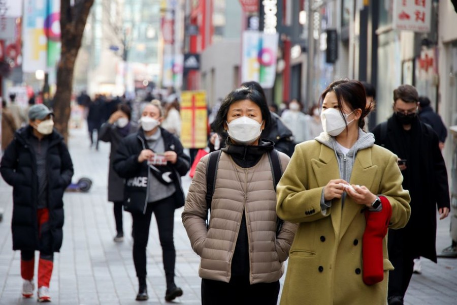 Women wearing masks walk in a shopping district amid the coronavirus disease (Covid-19) pandemic in Seoul, South Korea on November 29, 2021 — Reuters/Files