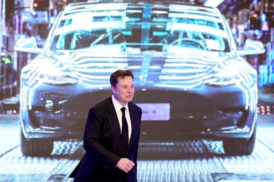 Tesla CEO Elon Musk walks next to a screen showing an image of Tesla Model 3 car during an opening ceremony for Tesla China-made Model Y programme in Shanghai, China on January 7, 2020 — Reuters/Files