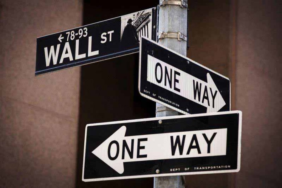 A 'Wall St' sign is seen above two 'One Way' signs in New York August 24, 2015 – Reuters/Lucas Jackson/File Photo