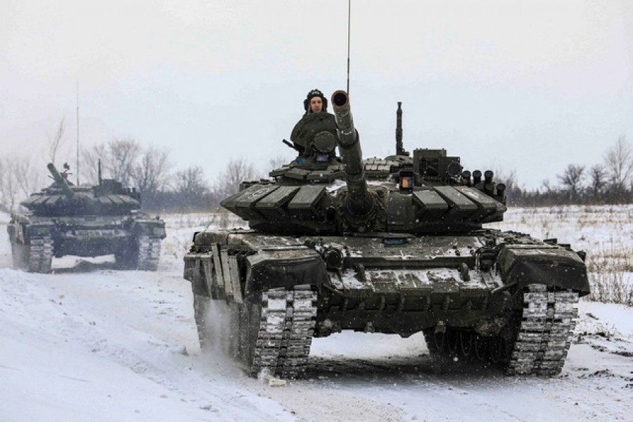 Russian servicemen drive tanks during military exercises in the Leningrad Region, Russia, in this handout picture released February 14, 2022 – Russian Defence Ministry/Handout via Reutes