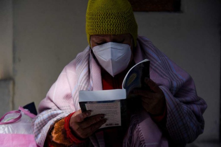 An inmate reads the bible in prison where she and fellow inmates have access to a small library as part of a program that aims to spread literacy and offer the chance to get out of jail earlier, in La Paz, Bolivia April 29, 2022. REUTERS