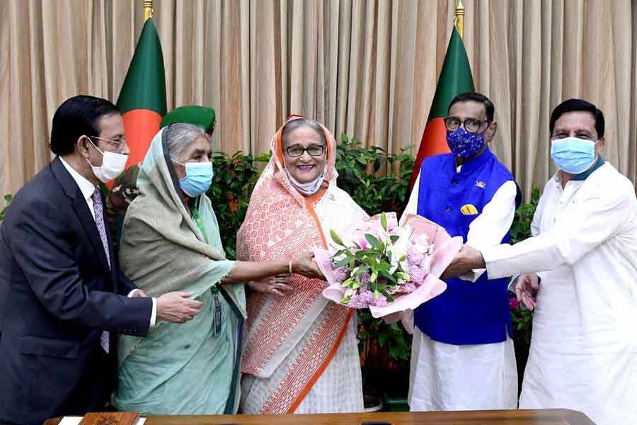 Awami League leaders greeting Prime Minister Sheikh Hasina at Ganabhaban on Saturday marking the 14th anniversary of the Awami League president’s release from prison –PID Photo