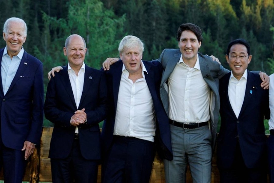 US President Joe Biden, German Chancellor Olaf Scholz, British Prime Minister Boris Johnson, Canadian Prime Minister Justin Trudeau and Japanese Prime Minister Fumio Kishida pose for a photograph next to a bench where Germany's then-Chancellor Angela Merkel and US then-President Barack Obama were photographed during a G7 summit in 2015, during the first day of the G7 leaders' summit at Bavaria's Schloss Elmau castle, near Garmisch-Partenkirchen, Germany, June 26, 2022. Reuters