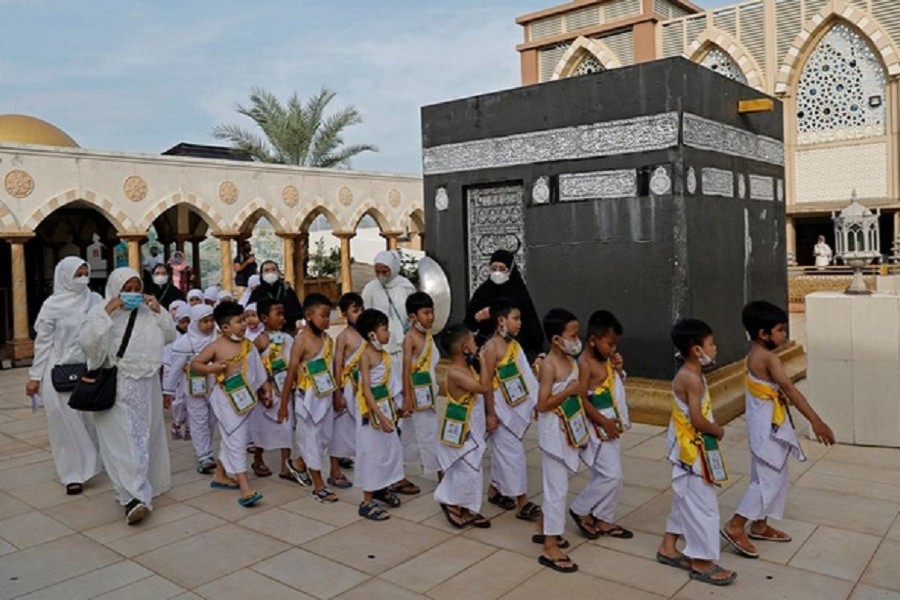 Kindergarten students walk near to a replica of the Kaaba as they perform Tawaf while practising for the haj pilgrimage at the Nurul Iman mosque in Jakarta, Indonesia, Jun 9, 2022. Reuters