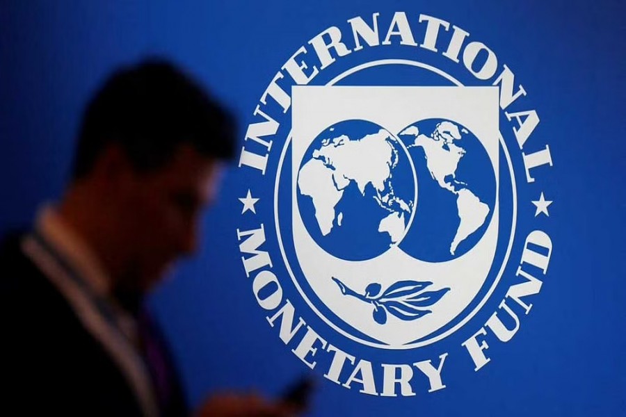 A participant stands near a logo of IMF at the International Monetary Fund - World Bank Annual Meeting 2018 in Nusa Dua, Bali, Indonesia, Oct 12, 2018. REUTERS