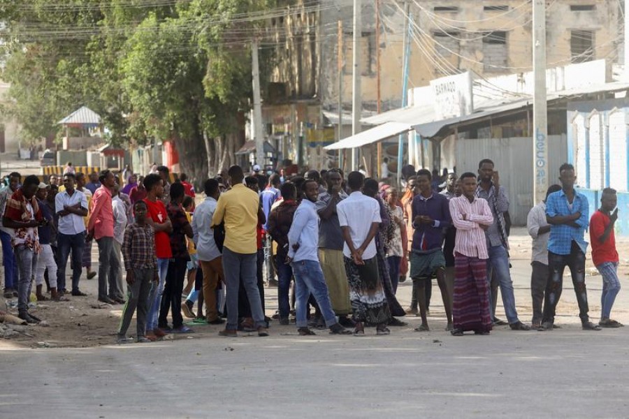 Somali people gather on the street during fighting between Somali government forces and opposition troops over delayed elections in Mogadishu, Somalia Feb 19, 2021. REUTERS/File