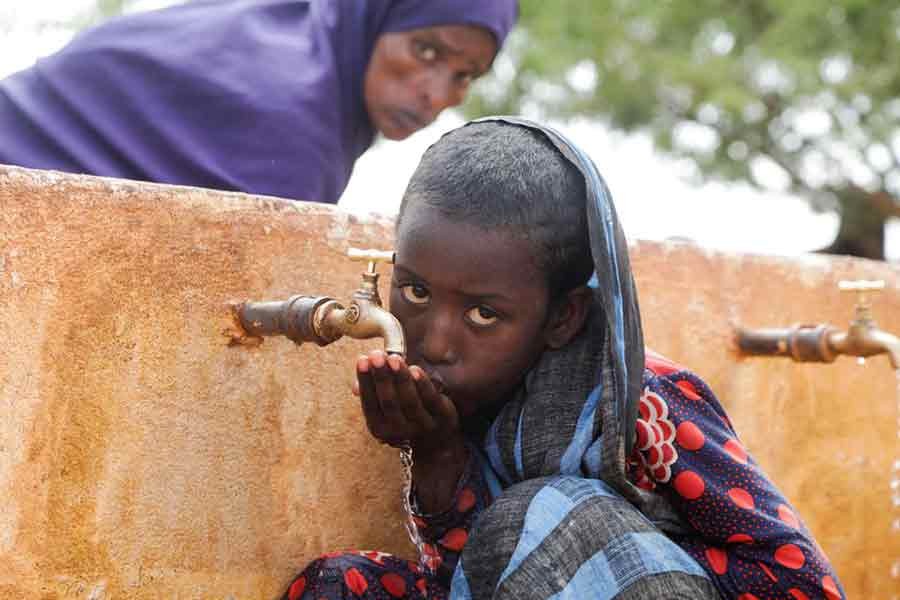 Somali displaced girl Sadia Ali, 8, drinking water from a tap at the Kaxareey camp for the internally displaced people in Gedo region of Somalia on May 24 this year –Reuters file photo