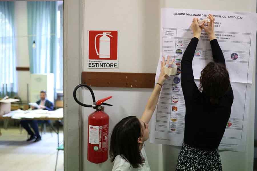 Polling station workers placing a ballot poster ahead of the September 25 snap election in Rome of Italy on Saturday –Reuters photo