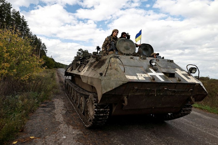 Ukrainians ride an armoured vehicle, amid Russia's attack on Ukraine, in Donesk region, Ukraine, October 3 2022. REUTERS/Zohra Bensemra