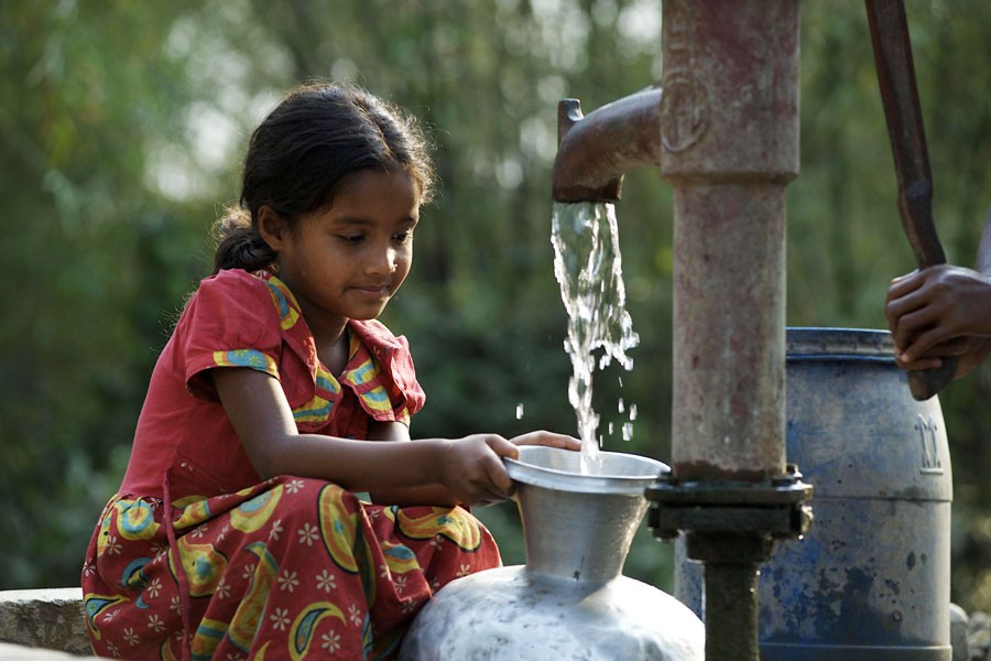 A child is collecting drinking water from a tubewell. Safe and clean water is still a big challenge in Bangladesh.  	—UNICEF Photo