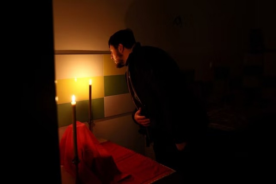 Father Victor blows candles out after holding a Sunday service for a handful of locals in the basement of his church, which is without power, water and heat after the building where she lived, was shelled a week ago, as Russia's invasion on Ukraine continues, in Siversk, Ukraine, December 4, 2022.REUTERS