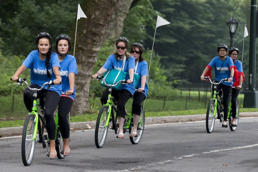 Sets of twins ride on tandem bicycles in New York's Central Park, July 15, 2015. REUTERS/Brendan McDermid/File Photo