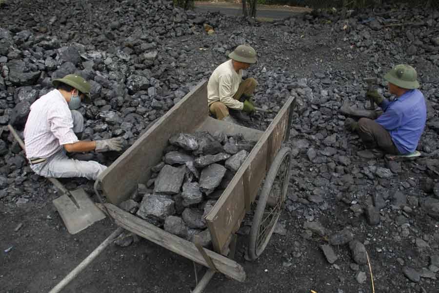 Workers picking out gravel from coal at a coal port in Hanoi  -Reuters file photo