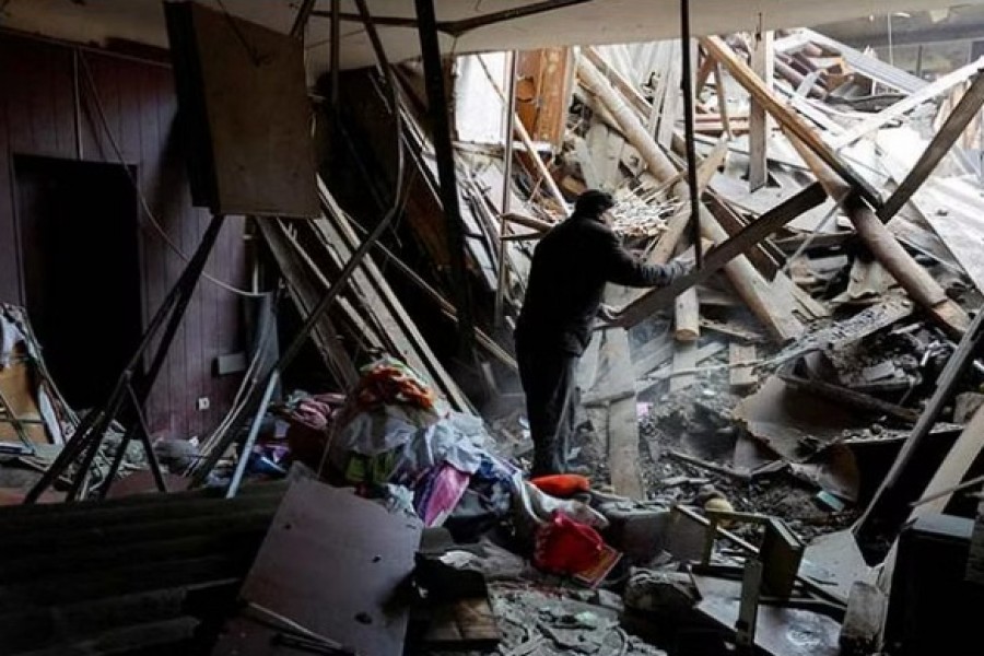 Local resident Sergei stands amid debris while gathering his belongings in an apartment inside a building heavily damaged in recent shelling in the course of Russia-Ukraine conflict in Horlivka (Gorlovka) in the Donetsk region, Russian-controlled Ukraine, December 13, 2022. REUTERS/Alexander Ermochenko