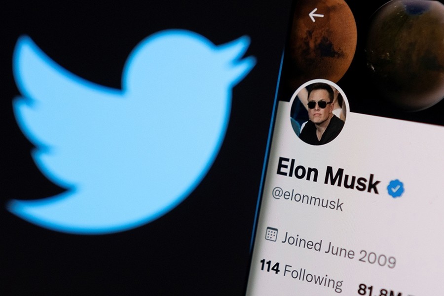 Elon Musk's twitter account is seen on a smartphone in front of the Twitter logo in this photo illustration taken on April 15, 2022 — Reuters/Files