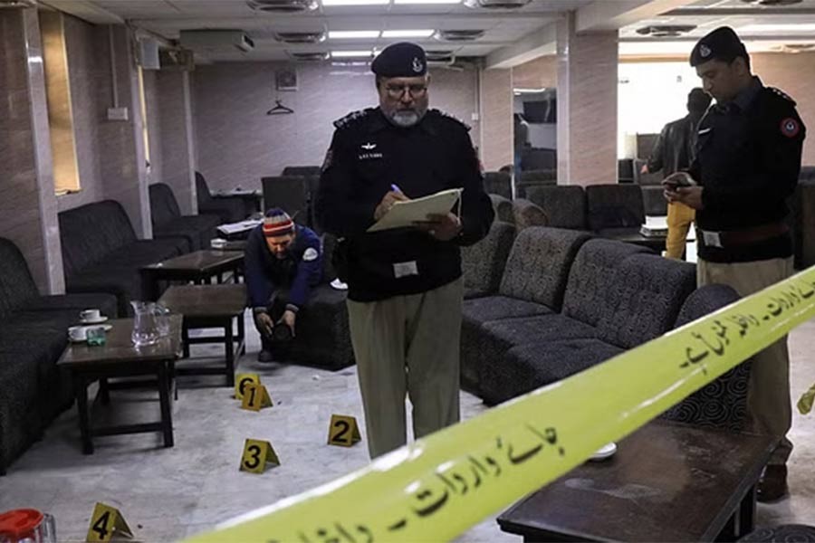 Police officers inspect the crime scene after, according to police, a gunman killed Abdul Latif Afridi, lawyer and former president of Pakistan’s Supreme Court Bar Association, in Peshawar of Pakistan on Monday.
