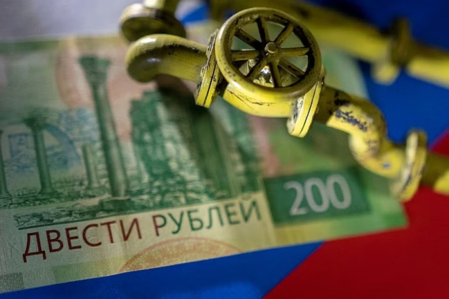 A model of the natural gas pipeline is placed on Russian Rouble banknote and a flag in this illustration taken, March 23, 2022. REUTERS