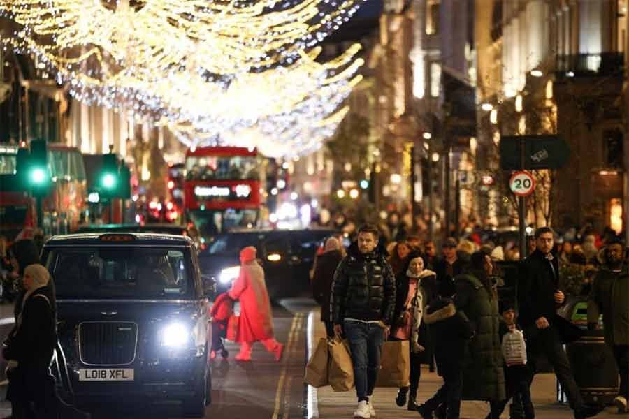 People walking past Christmas themed shop displays on Regent Street in London on December 4 last year –Reuters file photo