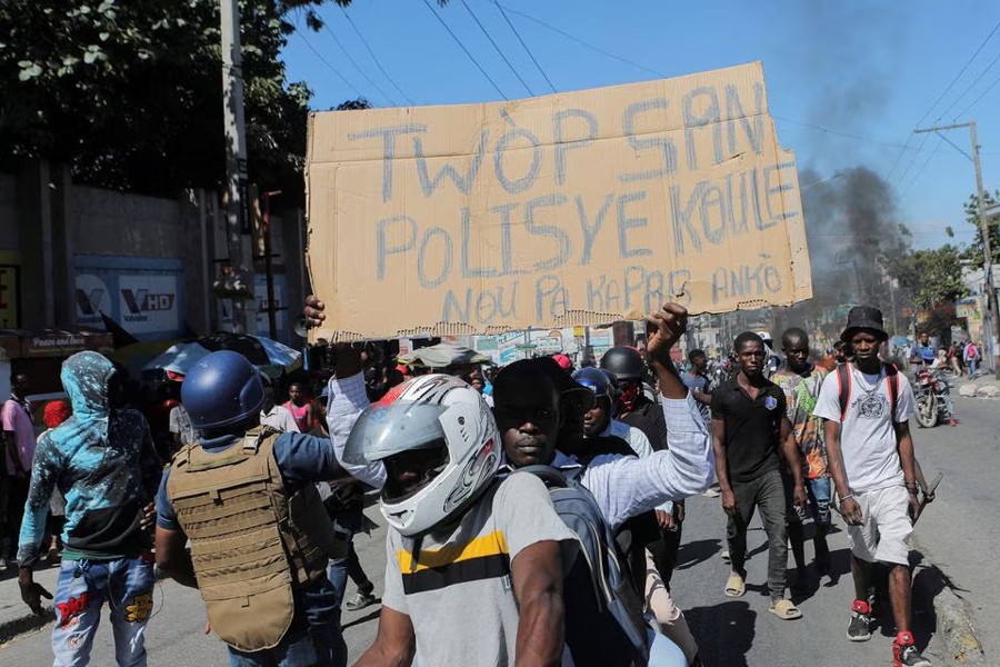 A demonstrator holds up a sign reading: "Too much police blood is being spilled. We can't take it anymore" during a protest for the recent killings of police officers by armed gangs, in Port-au-Prince, Haiti on January 26, 2023 — Reuters photo