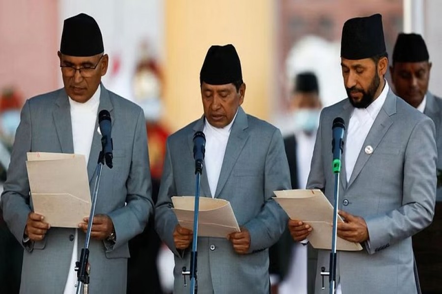 Bishnu Prasad Paudel (L), Deputy Prime Minister and Finance Minister along with Narayan Kaji Shrestha (C), Deputy Prime Minister and Minister of Physical Infrastructure and Transport and Rabi Lamichhane (R), Deputy Prime Minister and Home Minister administer the oath of office at the presidential building "Shital Niwas" in Kathmandu, Nepal, Dec 26, 2022. REUTERS/Navesh Chitrakar/File Photo