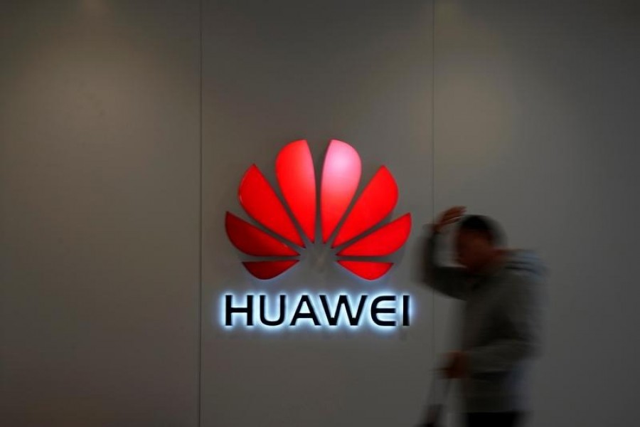 A man walks by a Huawei logo at a shopping mall in Shanghai, China on December 6, 2018 — Reuters/Files