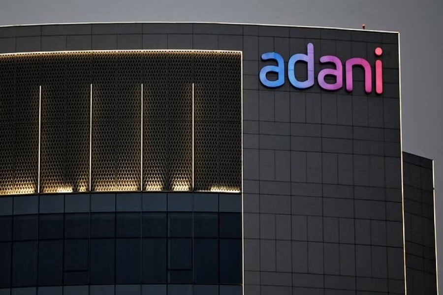 The logo of the Adani Group is seen on the facade of one of its buildings on the outskirts of Ahmedabad, India, Apr 13, 2021. REUTERS