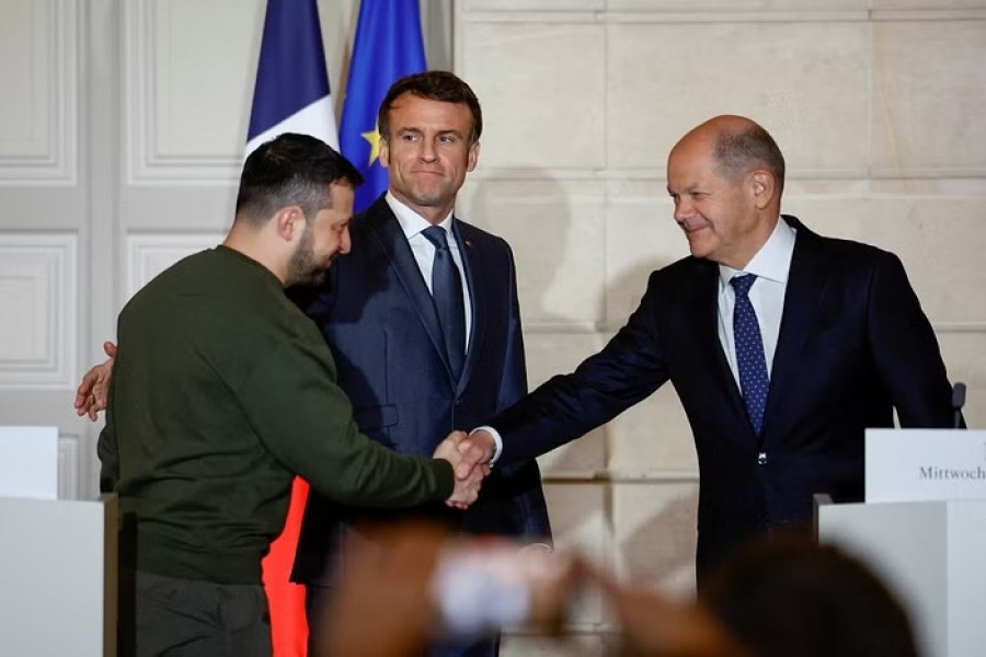Ukraine's President Volodymyr Zelenskiy and German Chancellor Olaf Scholz shake hands during a joint statement with French President Emmanuel Macron, at the Elysee Palace in Paris, France, February 8, 2023. REUTERS