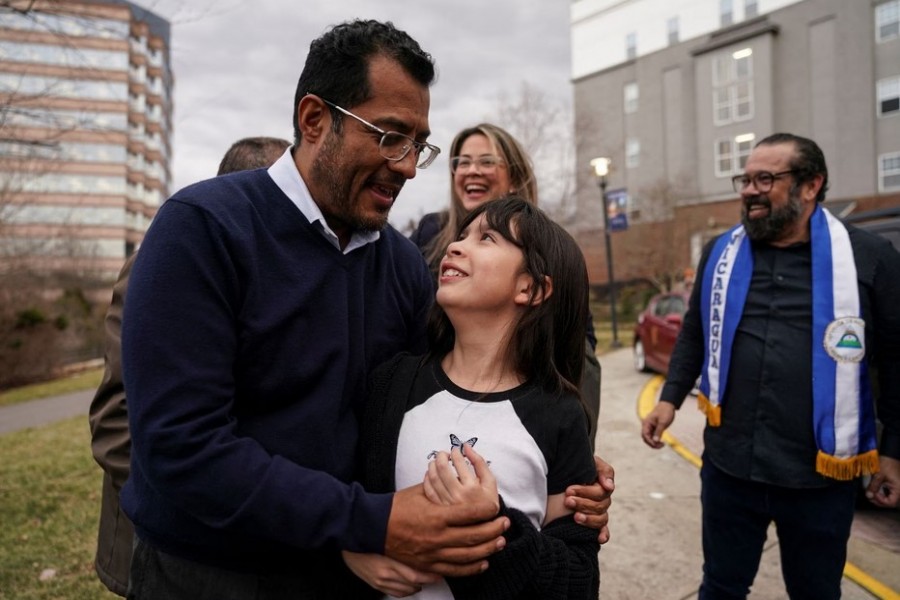 Former Nicaraguan presidential hopeful Felix Maradiaga, one of the more than 200 freed political prisoners from Nicaragua, embraces his daughter, Alejandra, as he celebrates with supporters and his wife, Berta Valle, outside a hotel after arriving in the United States at nearby Dulles International Airport in Northern Virginia near Washington, U.S., February 9, 2023. REUTERS/Kevin Lamarque