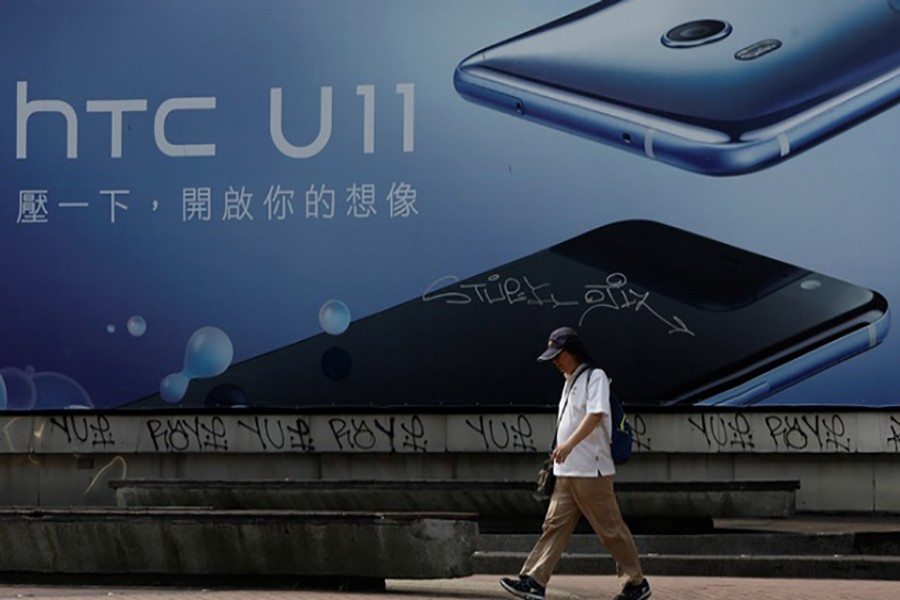 A man walks past a HTC advertisement board in Taipei, Taiwan on Thursday. - Reuters photo