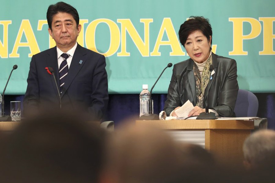 Party of Hope leader Yuriko Koike, right, speaks as Ruling Liberal Democratic Party leader and Japan’s Prime Minister Shinzo Abe listens  during the party leaders’ debate in Tokyo on Sunday for lower house election. -AP Photo