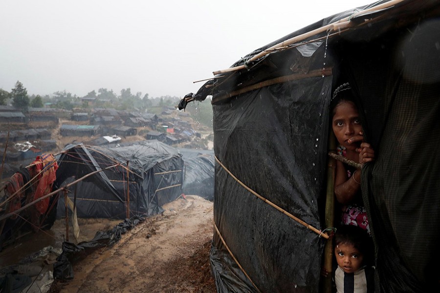 Rohingya refugees look out from a shelter in Cox's Bazar recently. - Reuters file photo