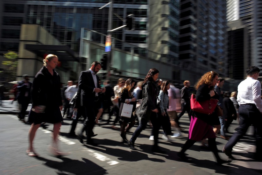 Office workers and shoppers walk through Sydney's central business district in Australia. 	— Reuters