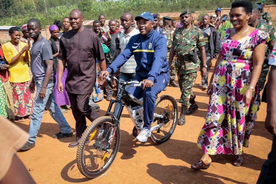 In thus file photo, president Pierre Nkurunziza, center, arrives by bicycle, accompanied by first lady Denise Bucumi Nkurunziza, right, to cast his vote for the presidential election in Burundi.  - AP photo