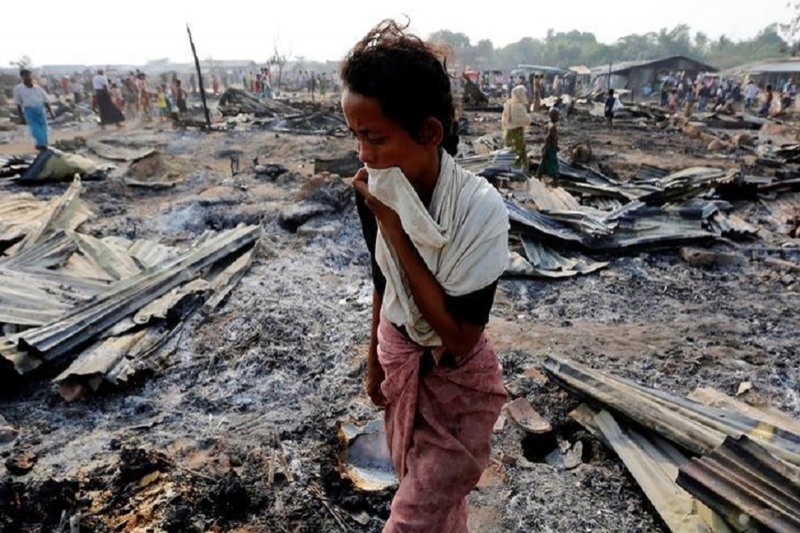 A woman walks among debris after fire destroyed shelters at a camp for internally displaced Rohingyas in the western Rakhine State near Sittwe, Myanmar May 3, 2016. Reuters/Files