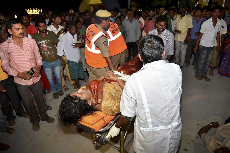 An injured being taken to hospital after an overloaded boat carrying 38 people capsized in the Krishna river near Vijayawada on Sunday evening. - PTI photo
