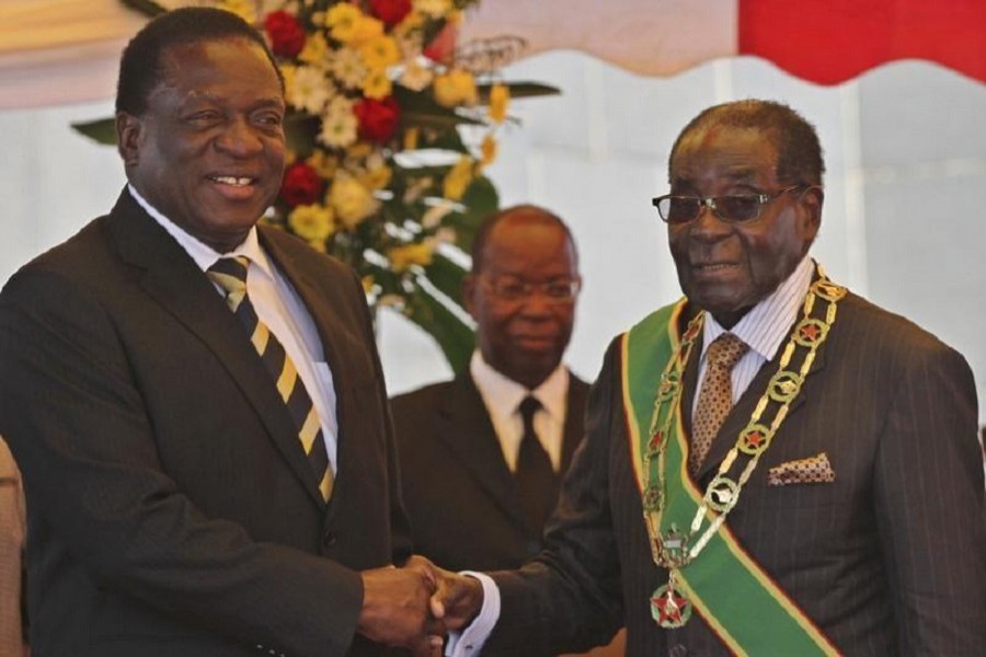 President Robert Mugabe (R) greets Vice President Emmerson Mnangagwa as he arrives for Zimbabwe's Heroes Day commemorations in Harare, August 10, 2015. Reuters