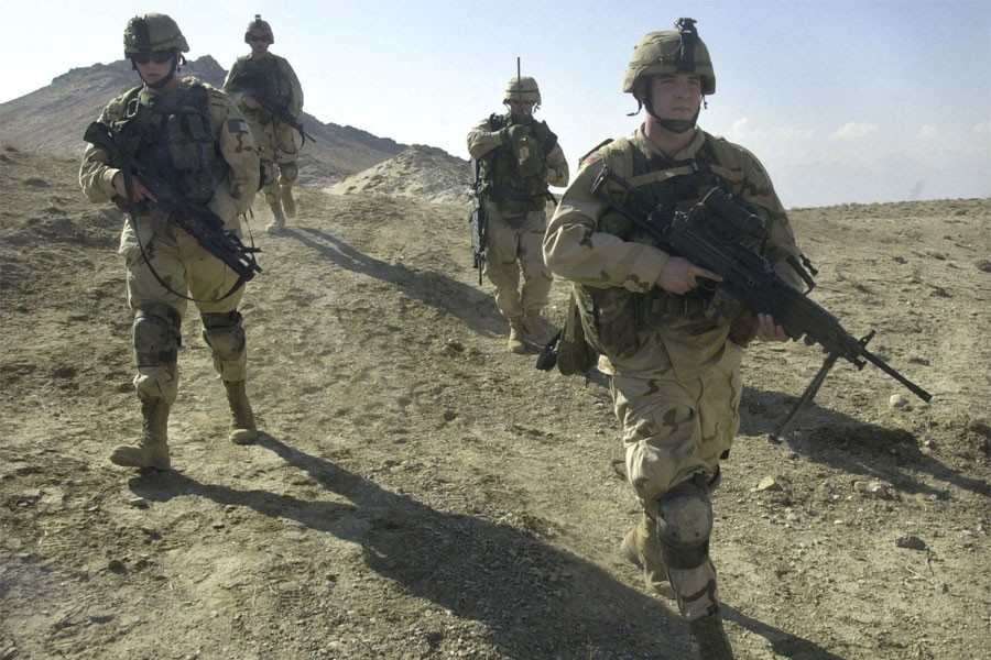 US soldiers patrol the perimeter of a weapons cache four miles of the US military base in Bagram, Afghanistan. (AP Photo)