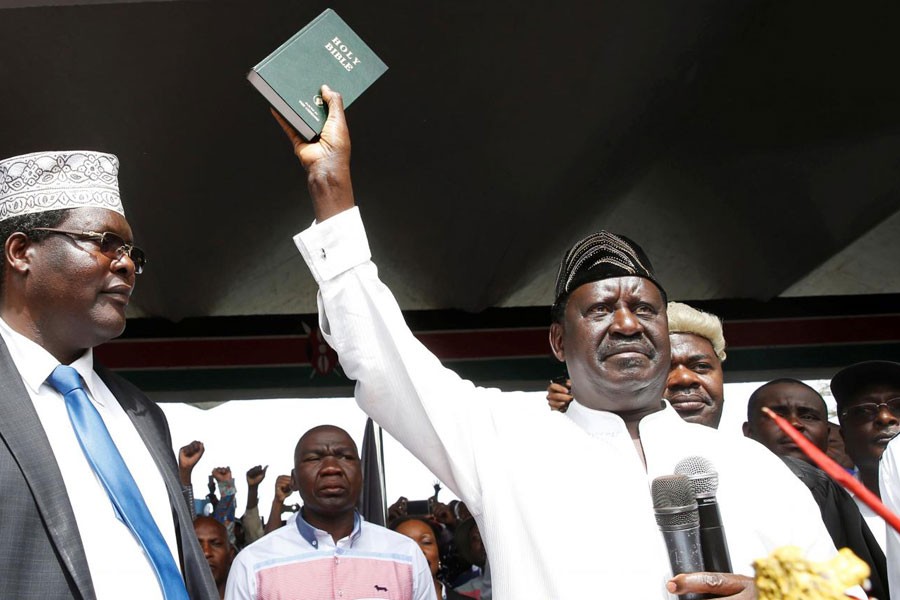 Kenyan opposition leader Raila Odinga of the National Super Alliance (NASA) holds a bible as he takes a symbolic presidential oath of office in Nairobi, Kenya January 30, 2018. (REUTERS)