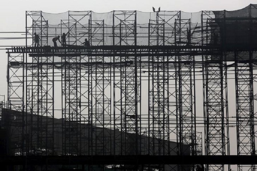 Labourers work at the construction site of a commercial complex on the outskirts of Kolkata, India, January 29, 2016. Reuters/File Photo