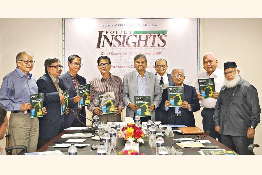 State Minister for Finance and Planning M A Mannan along with other dignitaries holding the copies of Policy Insights, a new publication of Policy Research Institute of Bangladesh (PRI), at its launching ceremony in the capital on Monday 	— FE Photo