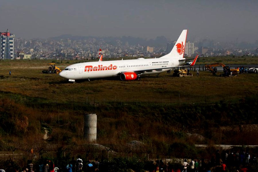 People gather near an aircraft belonging to Malindo Air that skidded off the runway on Friday night at Tribhuvan International Airport in Kathmandu of Nepal. -Reuters Photo