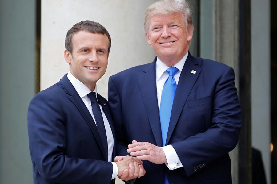 French President Emmanuel Macron greets US President Donald Trump at the Elysee Palace in Paris, France, July 13, 2017. Reuters file photo.