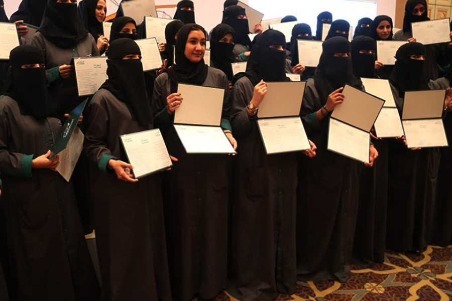Saudi women posing for photographs with their certificates during the graduation ceremony of Saudi women car-accident inspectors on Thursday. -Reuters Photo