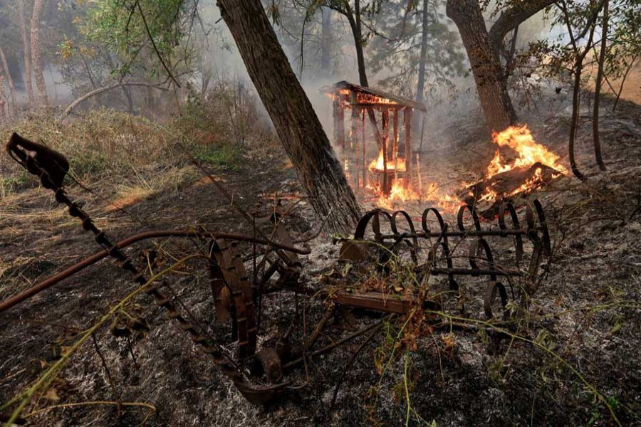 A wooden structure burns on the south edge of the Carr Fire near Igo, California, US, July 29, 2018. Reuters
