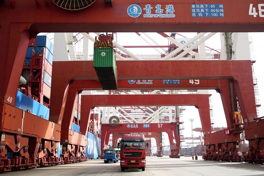 Trucks transport containers at a port in Qingdao, Shandong province in China on April 8 last — Reuters/File