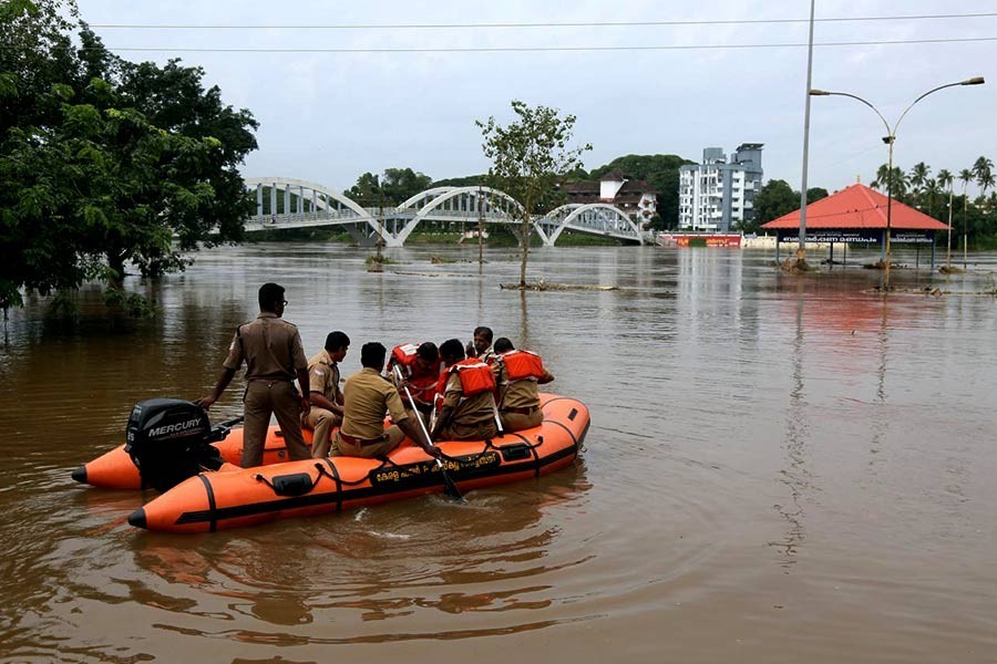 Rescue personnel patrolling the flooded waters on the banks of Periyar River after the opening of Idamalayar and Cheruthoni dam shutters following heavy rains, on the outskirts of Kochi on Friday - Reuters Photo