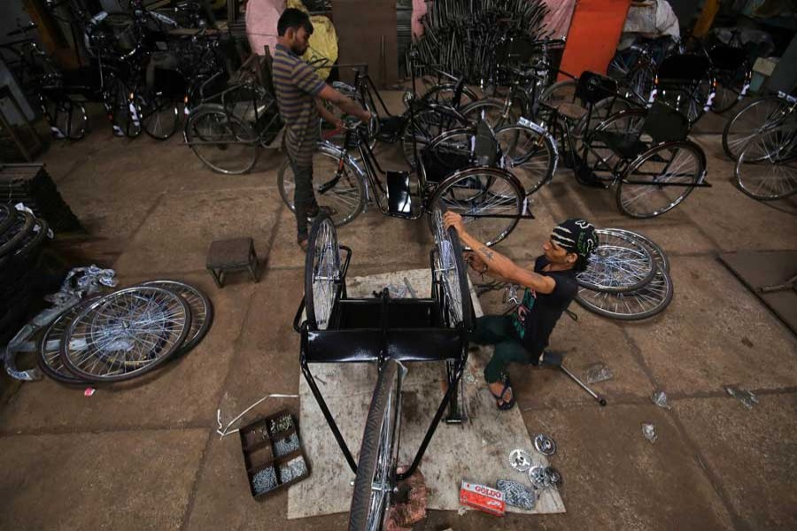 Workers assemble tricycles inside a manufacturing unit in Ahmedabad, India, August 30, 2018. Reuters